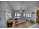 Bright bonus room with large windows, granite counters, and a ceiling fan, providing ample natural light at 3251 S Parkridge Ave, Pahrump, NV 89048
