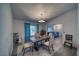Bright dining room featuring a decorative chandelier, wood table and cushioned chairs, complemented by wood-look floors at 3251 S Parkridge Ave, Pahrump, NV 89048