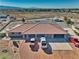 Large, single-story home with a red tile roof, multiple garages, and ample parking in a desert setting at 3251 S Parkridge Ave, Pahrump, NV 89048