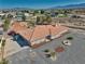 Single-story home features a red tile roof, desert landscaping, and a gravel yard with a fire pit at 3251 S Parkridge Ave, Pahrump, NV 89048