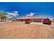 The front of the house has a desert landscape and a wide driveway for parking at 3251 S Parkridge Ave, Pahrump, NV 89048