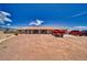 Expansive single-story home boasts a large gravel driveway and inviting curb appeal under a clear blue sky at 3251 S Parkridge Ave, Pahrump, NV 89048