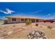 Charming single-story home featuring desert landscaping, a red tile roof, and a spacious front yard at 3251 S Parkridge Ave, Pahrump, NV 89048