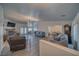 Open-concept living room features hardwood floors, fireplace, and view to dining at 3251 S Parkridge Ave, Pahrump, NV 89048