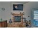 Inviting living room with a cozy fireplace featuring stone accents, offering a warm and rustic ambiance at 3251 S Parkridge Ave, Pahrump, NV 89048