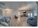 Open-concept living space with ample seating, hardwood floors, and a fireplace, perfect for entertaining guests at 3251 S Parkridge Ave, Pahrump, NV 89048