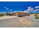 Back of the home showing large gravel lot, and covered patio at 3251 S Parkridge Ave, Pahrump, NV 89048