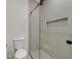 Bathroom featuring a glass shower enclosure with a toilet and hardware in the corner at 328 Hedgehope Dr, Las Vegas, NV 89183