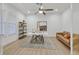 Bright office space with a modern desk, tan leather sofa, and a ceiling fan at 328 Hedgehope Dr, Las Vegas, NV 89183