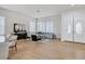 Spacious living room with light hardwood floors, modern decor, and plenty of natural light at 328 Hedgehope Dr, Las Vegas, NV 89183