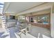 Covered patio with an outdoor kitchen, built in TV, stainless steel appliances, and seating at 328 Hedgehope Dr, Las Vegas, NV 89183