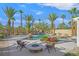 A backyard pool featuring rock features, a waterfall, and in-pool seating at 328 Hedgehope Dr, Las Vegas, NV 89183