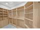 Spacious walk-in closet featuring wooden shelving units and ample storage space at 328 Hedgehope Dr, Las Vegas, NV 89183