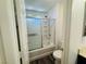 Clean bathroom featuring a glass-enclosed shower/tub combination with tile surround and modern fixtures at 3508 Harbor Tides St, Las Vegas, NV 89147