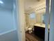 Well-lit bathroom featuring a shower-tub combination and wood-look flooring at 3508 Harbor Tides St, Las Vegas, NV 89147
