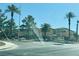Street view of the community entrance sign with lush landscaping and mature palm trees at 3508 Harbor Tides St, Las Vegas, NV 89147