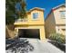 Two story home featuring an attached garage, small balcony, and desert landscaping at 3508 Harbor Tides St, Las Vegas, NV 89147