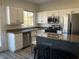 Kitchen featuring white cabinets and a granite island at 3508 Harbor Tides St, Las Vegas, NV 89147