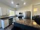 Bright kitchen featuring stainless steel appliances, white cabinets, and a center island at 3508 Harbor Tides St, Las Vegas, NV 89147