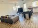 Open-concept living room featuring modern decor, wood floors, and a kitchen with a center island at 3508 Harbor Tides St, Las Vegas, NV 89147