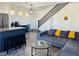 Open-concept living room featuring modern decor, wood floors, and a kitchen with a center island at 3508 Harbor Tides St, Las Vegas, NV 89147