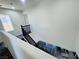Carpeted staircase with dark wood railing leads to a lower level with wood-look floors and a living area at 3508 Harbor Tides St, Las Vegas, NV 89147