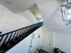 A staircase with carpeted steps and a dark railing leads to the upper level of this home at 3508 Harbor Tides St, Las Vegas, NV 89147