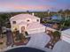 Stunning aerial view of a two-story home featuring a pool, lush landscaping, and a three-car garage at 352 Angels Trace Ct, Las Vegas, NV 89148