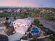 Aerial view of an estate home featuring a resort-style pool, outdoor living, and lush landscaping in a golf community at 352 Angels Trace Ct, Las Vegas, NV 89148