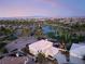 Home located in a golf course community with ponds, palm trees, and mountain and city views at 352 Angels Trace Ct, Las Vegas, NV 89148