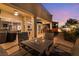 Covered patio with comfortable seating and an outdoor dining area for relaxing and entertaining guests at 352 Angels Trace Ct, Las Vegas, NV 89148