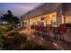 Expansive back patio with an outdoor bar, comfortable seating, and lush landscaping, ideal for entertaining at 352 Angels Trace Ct, Las Vegas, NV 89148