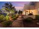 An outdoor kitchen and grilling area complement the beautiful and private hardscaped patio and lush green landscaping at 352 Angels Trace Ct, Las Vegas, NV 89148
