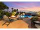 Stunning backyard oasis featuring a pool with a waterfall, fire pit, and comfortable seating area for relaxing evenings at 352 Angels Trace Ct, Las Vegas, NV 89148
