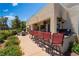 Inviting backyard featuring an outdoor kitchen, bar stools, and fire pit and view of the beautiful green landscape at 352 Angels Trace Ct, Las Vegas, NV 89148