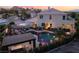 Inviting backyard features a pool with waterslide, covered patio, and fire pit seating area at 352 Angels Trace Ct, Las Vegas, NV 89148