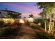 Private backyard patio with lush landscaping, cozy seating area, and serene ambiance at 352 Angels Trace Ct, Las Vegas, NV 89148
