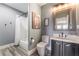 Gray bathroom with gray wood flooring, gray vanity and a walk in shower at 352 Angels Trace Ct, Las Vegas, NV 89148
