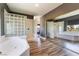 Bright primary bathroom with a large tub and glass block shower, perfect for relaxation at 352 Angels Trace Ct, Las Vegas, NV 89148