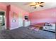 Pink bedroom with plush carpet, white dresser, and wall-mounted TV at 352 Angels Trace Ct, Las Vegas, NV 89148