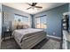 Cozy bedroom featuring calming blue walls, ample natural light, and a comfortable king-size bed at 352 Angels Trace Ct, Las Vegas, NV 89148