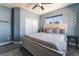 Cozy bedroom with blue walls, plush carpeting, and a large window with palm tree views at 352 Angels Trace Ct, Las Vegas, NV 89148