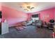 Bright pink bedroom features a ceiling fan, plush carpet, and comfortable furnishings at 352 Angels Trace Ct, Las Vegas, NV 89148