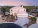 Stately two-story home with a three-car garage and beautifully landscaped front yard, showcasing curb appeal at 352 Angels Trace Ct, Las Vegas, NV 89148