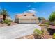 Charming two-story home with a three-car garage, mature landscaping, and an expansive driveway at 352 Angels Trace Ct, Las Vegas, NV 89148