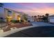 Charming two-story home featuring a well-manicured lawn, three-car garage, and inviting front entrance at 352 Angels Trace Ct, Las Vegas, NV 89148