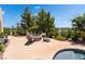 Backyard firepit and seating area with lush landscaping and serene lake views at 352 Angels Trace Ct, Las Vegas, NV 89148