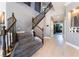 Elegant foyer with a grand staircase, modern lighting, and neutral color palette, creating a welcoming entrance at 352 Angels Trace Ct, Las Vegas, NV 89148