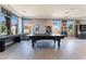 Entertaining game room with a pool table, foosball, and a stylish bar area, offering fun for all at 352 Angels Trace Ct, Las Vegas, NV 89148