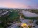 Beautiful golf course community with green grass, tall palm trees, body of water, and the Las Vegas Strip at 352 Angels Trace Ct, Las Vegas, NV 89148